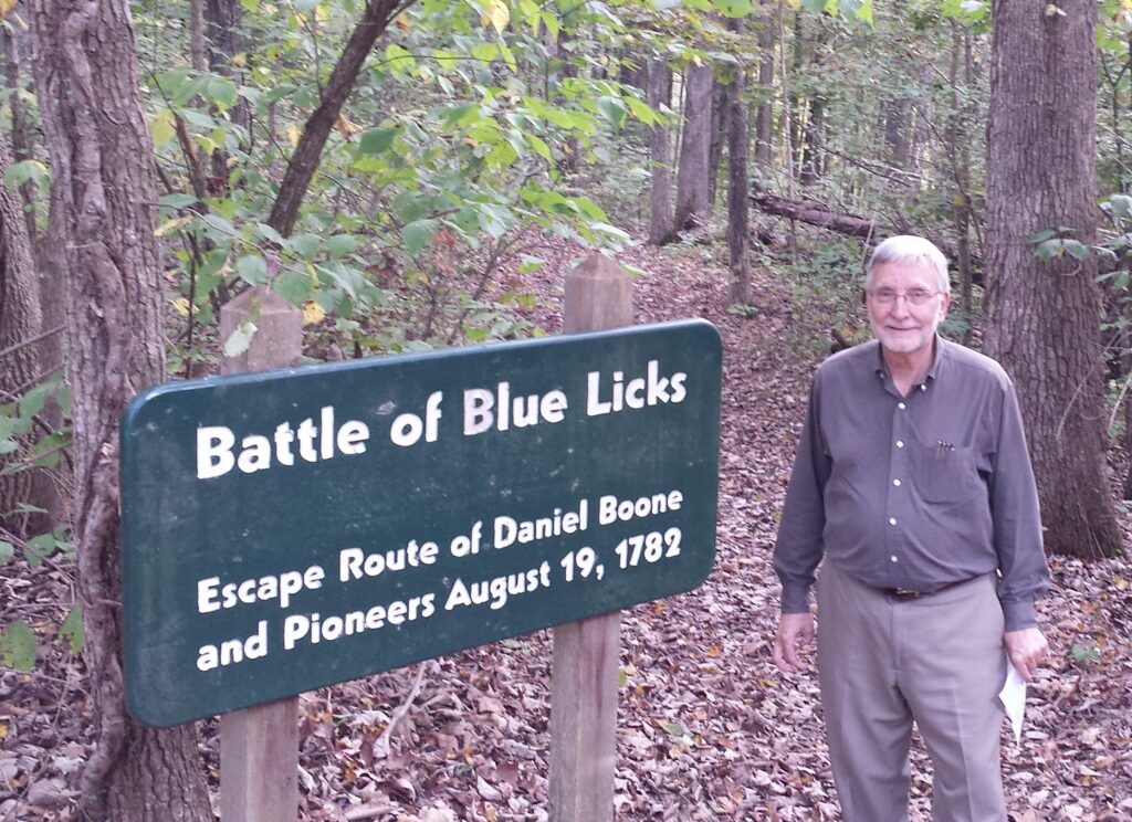 Man standing in woods near Licking River.